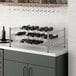 A Regency chrome wire wine rack holding 48 bottles of wine.
