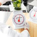 A person weighing a bowl of limes on a Cardinal Detecto portion scale.