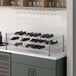 A Regency chrome wire wine shelf holding 22 bottles of wine.