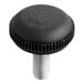 A black plastic cap with a screw on top with a number.
