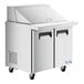 An Avantco stainless steel 2 door refrigerated sandwich prep table.