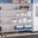A chrome 5-shelf wire shelving unit with casters, used for storage in commercial or industrial settings.