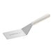 A white Dexter-Russell solid turner with a plastic handle.