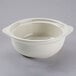 A white Tuxton onion soup bowl with a handle.