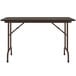 A Correll rectangular table with metal legs and a walnut top.