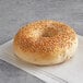 An Original Bagel with sesame seeds on top on a napkin.