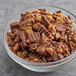 A bowl of chopped REESE'S Peanut Butter Cup topping on a table.