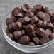 A bowl filled with Gertrude Hawk dark chocolate raspberry truffle cups.