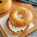 A bagel with apple cinnamon and cream cheese on top.