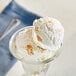 A glass bowl with a scoop of Flat Pie Chip Topping and Inclusion on ice cream.