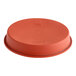 A round red silicone baking mold with a safety ring.