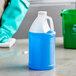 A blue jug of liquid on a counter.