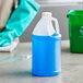 A translucent HDPE jug filled with blue liquid sitting on a counter.