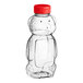 A 16 oz. clear plastic Bear PET honey bottle with a red cap.