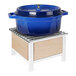 A maple wood chafer alternative with a lid on a white stand.