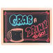 An Aarco oak-framed chalkboard with a drawing of a cup and text on a white background.