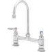 A chrome T&S deck-mount faucet with dual lever handles.