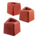 A close-up of a Silikomart Mini Cube silicone baking mold with red cubes inside.