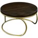 A round wooden table with a dark oak Cal-Mil display riser with gold legs.