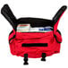 A red and black Medi-First emergency bag with medical supplies inside.