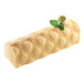 A close up of a dessert made using a Silikomart silicone baking mold with a green leaf on top.