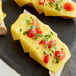 A plate with three Violife Just Like Smoked Provolone Vegan Cheese slices on bread with tomatoes.