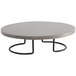A Cal-Mil round black and gray pine display riser on a round concrete table with metal legs.