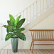 An LCG Sales artificial Dieffenbachia plant in a copper washed metal planter on a wooden bench.