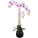 A black ceramic pot with artificial pink orchids.