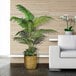 A 5' artificial Areca Palm tree in a basket next to a white couch.