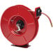 A red metal Reelcraft hose reel with a hose attached.