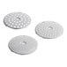 Three silver circular metal discs with holes.