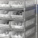 Regency clear plastic shelf bin on metal shelving