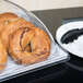 A Cal-Mil shallow white bakery tray holding bagels on a hotel buffet counter.