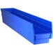 A Regency blue plastic shelf bin with two compartments.