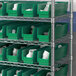 A row of Regency green plastic bins on a shelf.