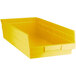 A yellow plastic Regency shelf bin.