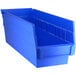 A Regency blue plastic shelf bin with two compartments.