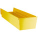 A yellow plastic Regency shelf bin with two compartments and a lid open.