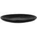 A close up of a black RAK Porcelain flat coupe plate with a rim.