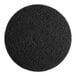 A black circular Lavex Basics stripping floor machine pad with a hole in the middle.