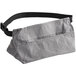 A grey waist bag with a black strap.