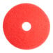 A red circular Lavex Basics floor machine pad with a hole in the middle.