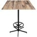 A Holland Bar Stool rustic wood table with a metal base.