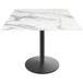 A white marble Holland Bar Stool table with a round black base.