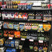 A shelf of beer and other beverages with labels and dividers.