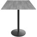 A Holland Bar Stool EuroSlim bar height table with a black base and a grey top.