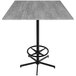 A Holland Bar Stool EuroSlim bar height table with a metal base and a grey square top.