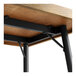 A Lancaster Table & Seating butcher block table top with black metal legs.