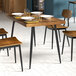 A Lancaster Table & Seating butcher block table with a wooden top and chairs.